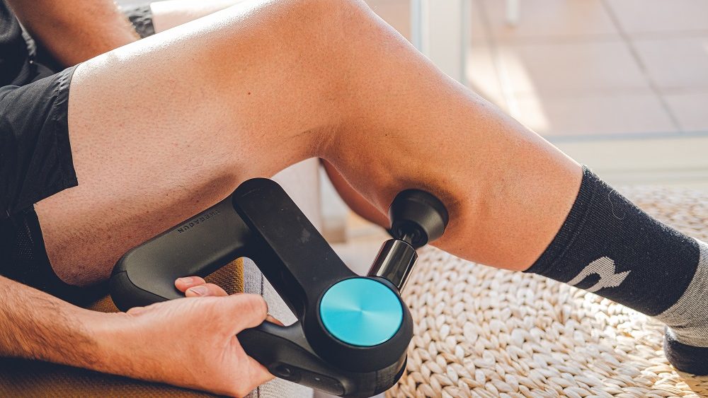 Massage des mollets avec un appareil de percussion pour éviter les crampes